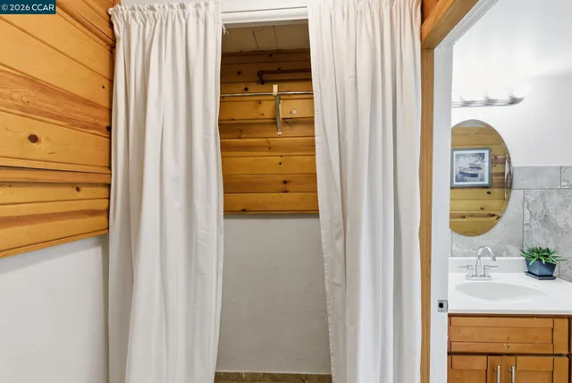 a bathroom with a sink a mirror and shower