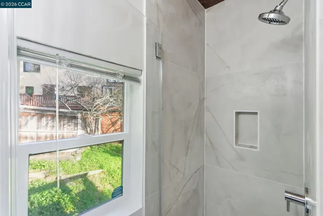 a view of a glass door with a yard from a window