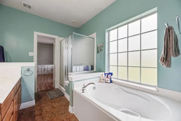 a bathroom with a tub sink and a mirror