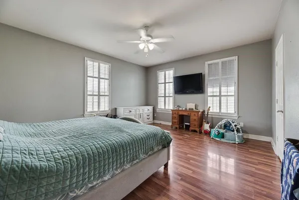 a bedroom with a bed window and a flat screen tv