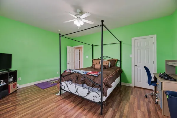 a bedroom with a bed and a flat screen tv