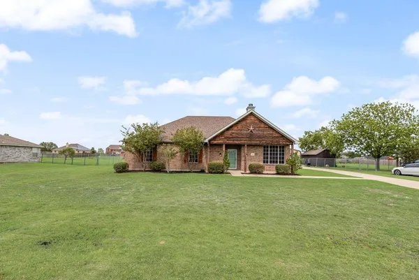 a big house with a big yard and large trees
