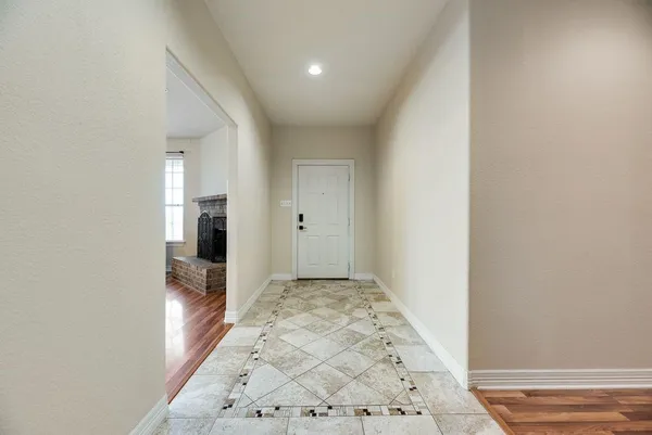 a view of hallway with wooden floor