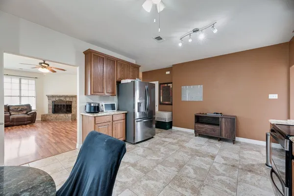 a kitchen with kitchen island granite countertop a sink counter top space appliances and cabinets