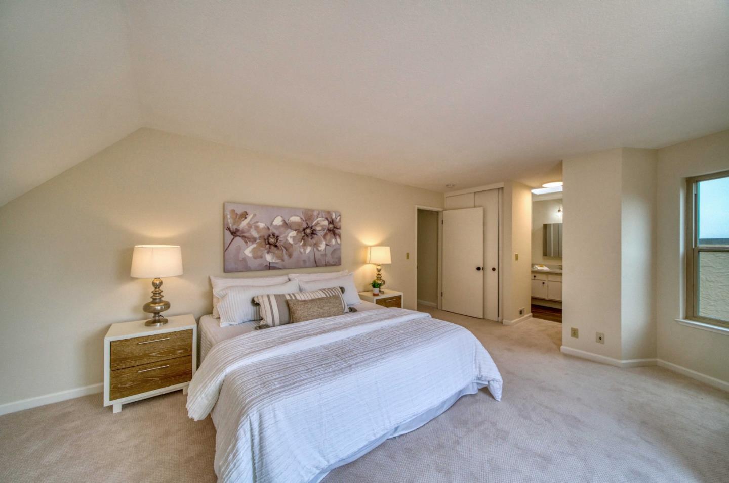 457 Roberts Road Pacifica, CA 94044 - Photo 16 of 29 a bedroom with a bed and a painting on the wall