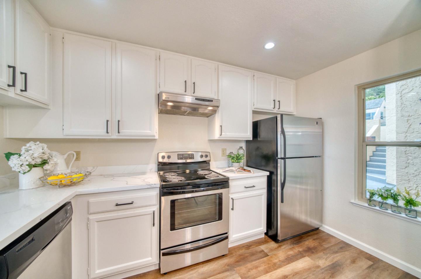 457 Roberts Road Pacifica, CA 94044 - Photo 5 of 29 a kitchen with a white stove and refrigerator