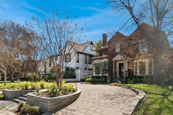 a view of a white house with a yard and plants