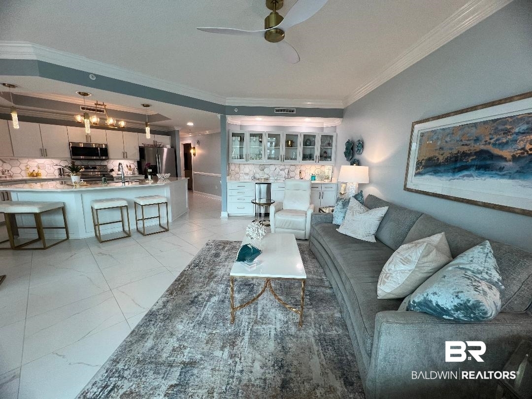 27580 Canal Road, Unit 1210 Orange Beach, AL 36561 - Photo 6 of 28 Living room with ornamental molding, light marble finish floors, and ceiling fan