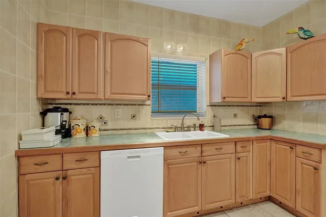 a kitchen with stainless steel appliances granite countertop a sink dishwasher stove and cabinets