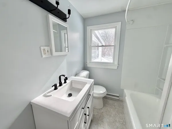 a bathroom with a sink toilet and a bathtub