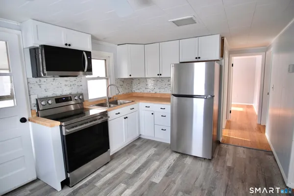 a kitchen with a refrigerator stove and microwave
