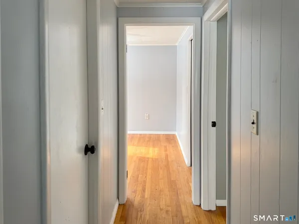 a view of a hallway with wooden floor