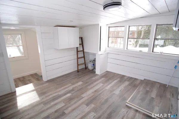 a room with a hardwood floor and window