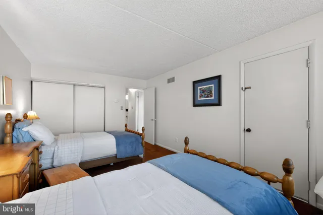 a bedroom with two beds and a lamp