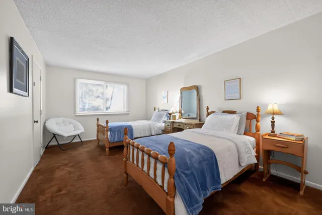 a bedroom with two beds and a window