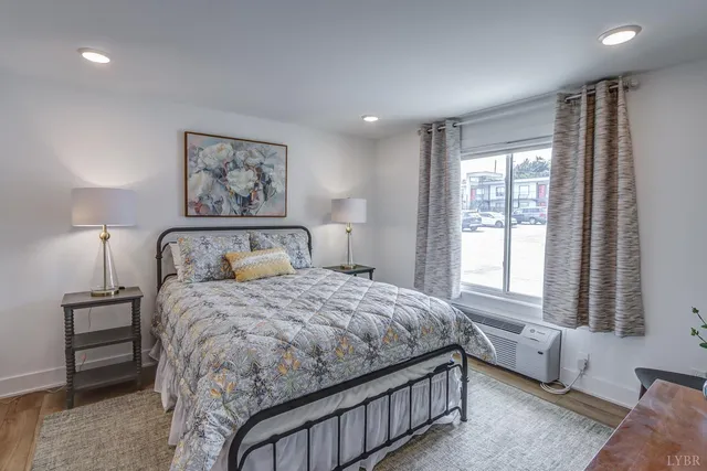 a bedroom with a large bed and a window