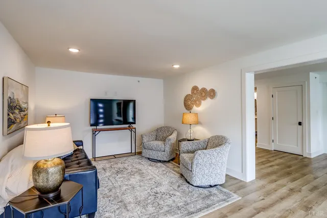 a living room with furniture and wooden floor