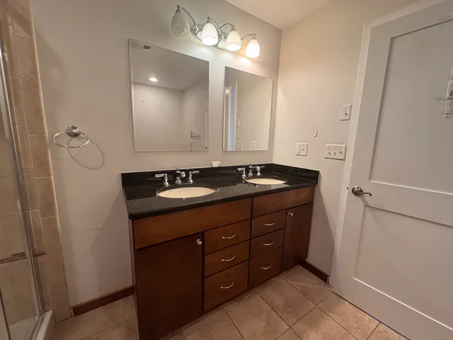 a bathroom with a sink vanity and a mirror