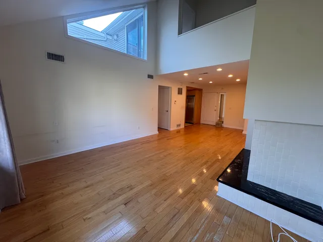 a view of a hall with wooden floor