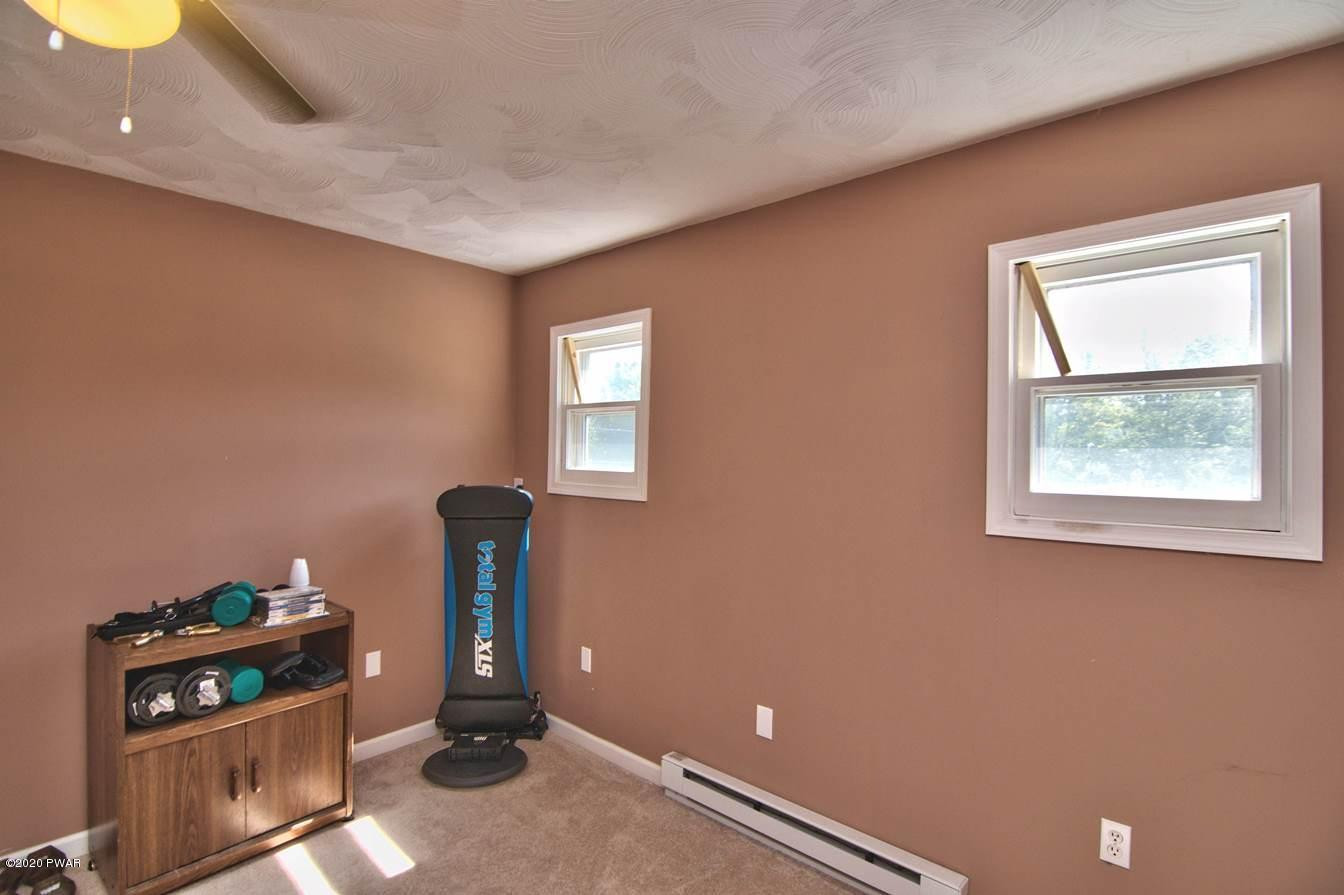 5690 Haas Pond Road Moscow, PA 18444 - Photo 57 of 79 a room with gym equipment and a window
