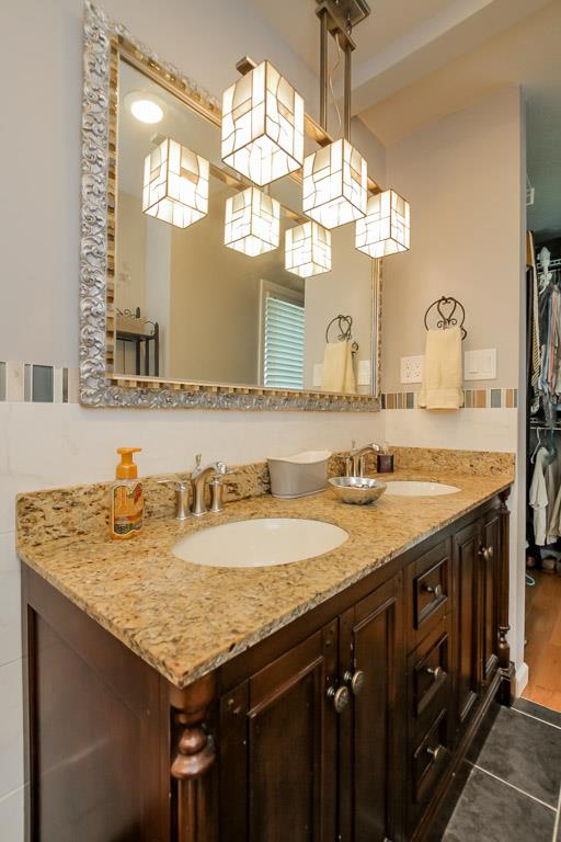 283 Lee Road Cottontown, TN 37048 - Photo 15 of 29 a bathroom with a granite countertop sink a large mirror and a window