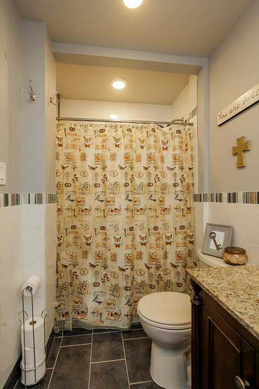 283 Lee Road Cottontown, TN 37048 - Photo 16 of 29 a bathroom with a granite countertop toilet and a shower