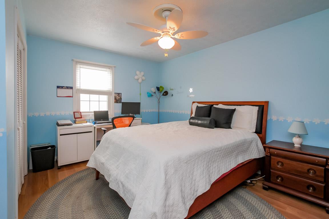 283 Lee Road Cottontown, TN 37048 - Photo 17 of 29 a bedroom with a bed and a chandelier