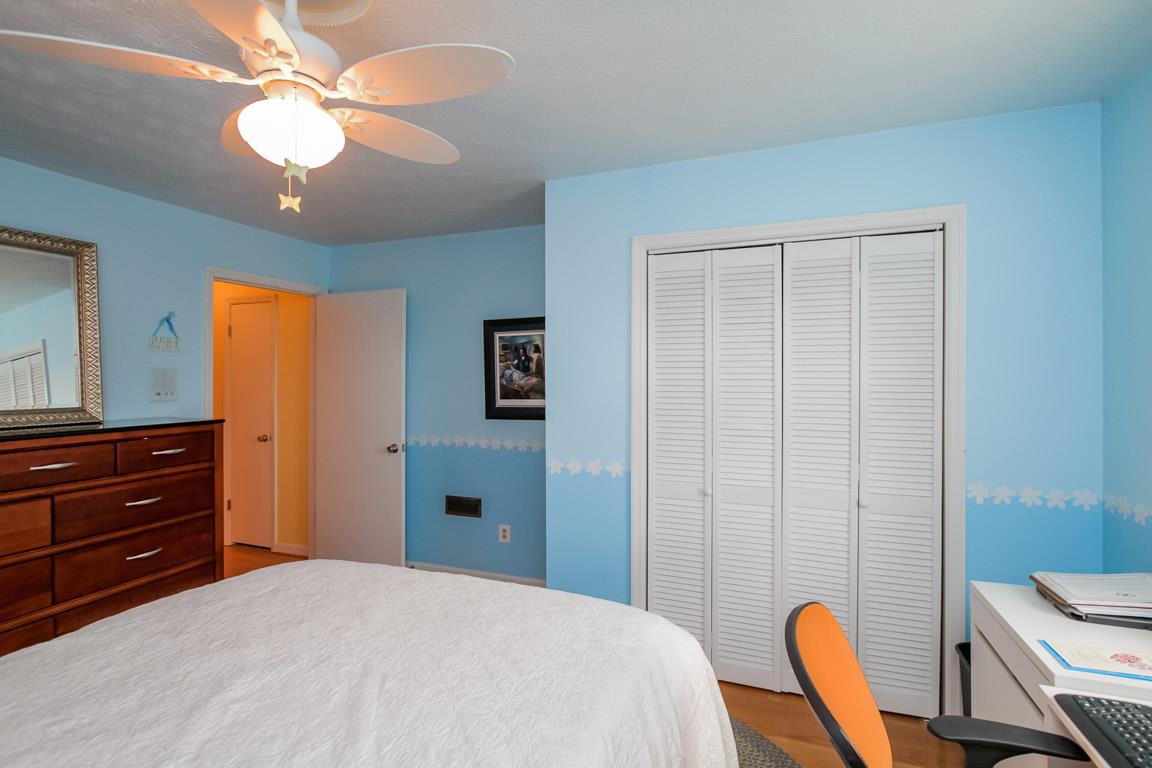 283 Lee Road Cottontown, TN 37048 - Photo 18 of 29 a bedroom with a bed and a chandelier