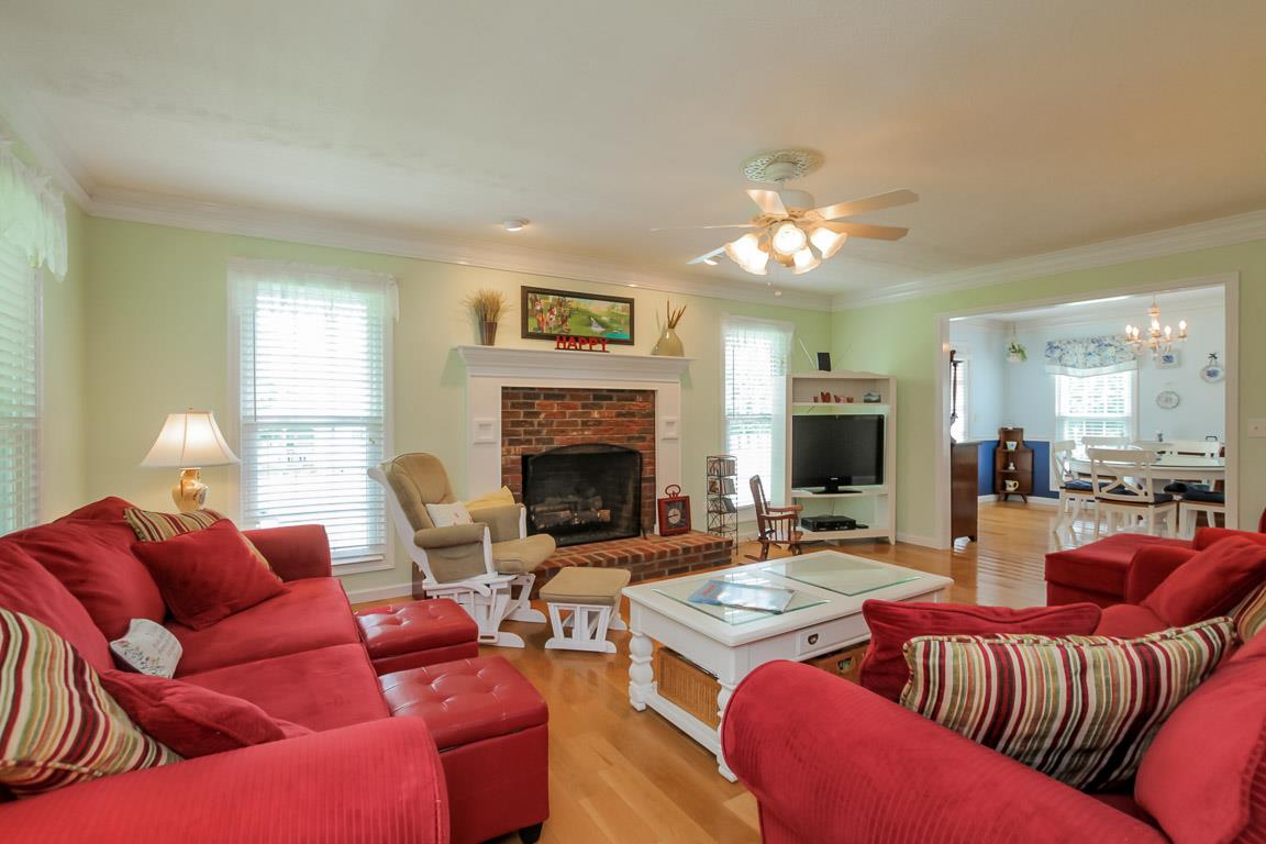 283 Lee Road Cottontown, TN 37048 - Photo 3 of 29 a living room with furniture a fireplace and a chandelier