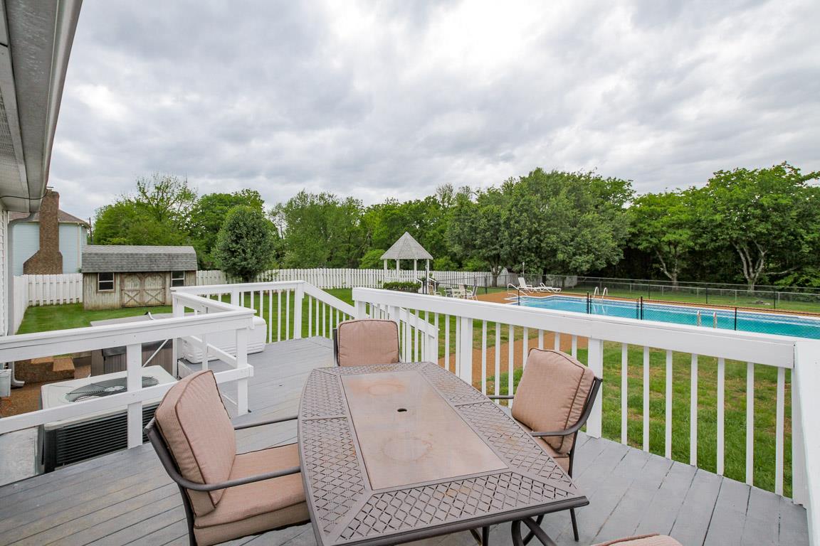 283 Lee Road Cottontown, TN 37048 - Photo 28 of 29 a roof deck with table and chairs a barbeque with wooden floor and fence
