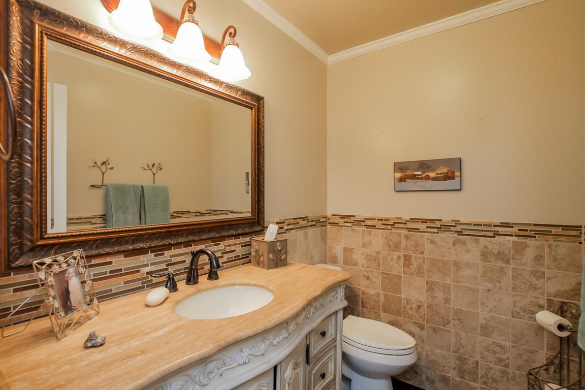 283 Lee Road Cottontown, TN 37048 - Photo 7 of 29 a bathroom with a granite countertop sink a toilet and a mirror