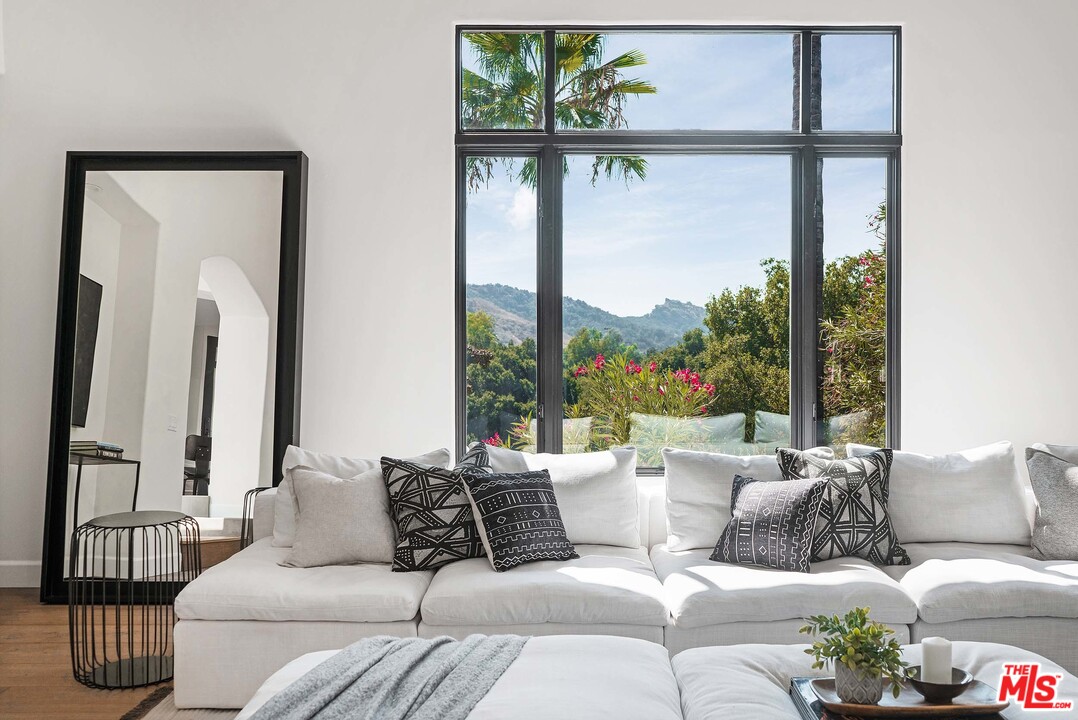 3170 Santa Maria Road Topanga, CA 90290 - Photo 17 of 60 a living room with furniture and a large window