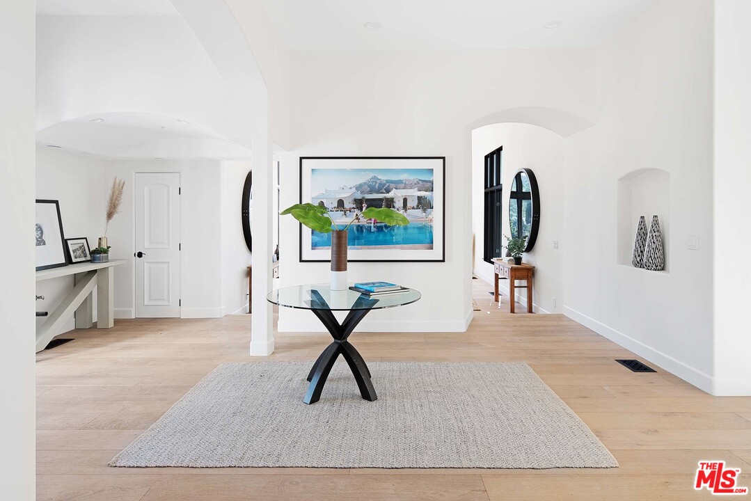 3170 Santa Maria Road Topanga, CA 90290 - Photo 18 of 60 a living room with furniture a wooden floor and a rug