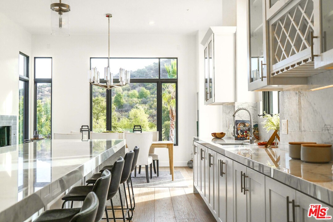 3170 Santa Maria Road Topanga, CA 90290 - Photo 20 of 60 a view of a kitchen with kitchen island stainless steel appliances a large window and living room