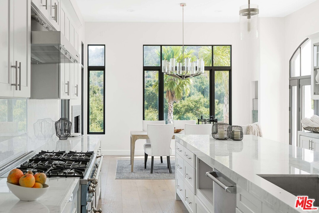 3170 Santa Maria Road Topanga, CA 90290 - Photo 21 of 60 a kitchen with stainless steel appliances a sink a stove and a window
