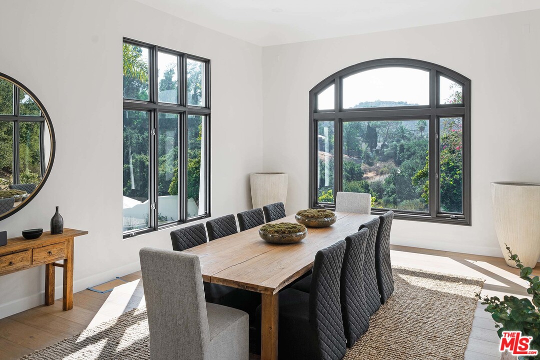 3170 Santa Maria Road Topanga, CA 90290 - Photo 29 of 60 a dining room with furniture a chandelier and wooden floor