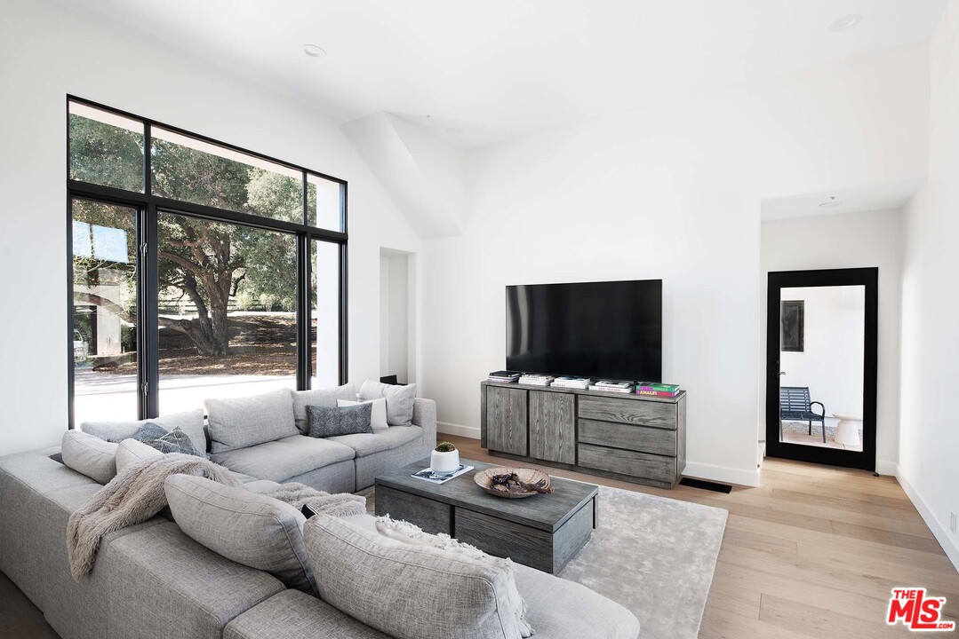 3170 Santa Maria Road Topanga, CA 90290 - Photo 30 of 60 a living room with furniture and a flat screen tv