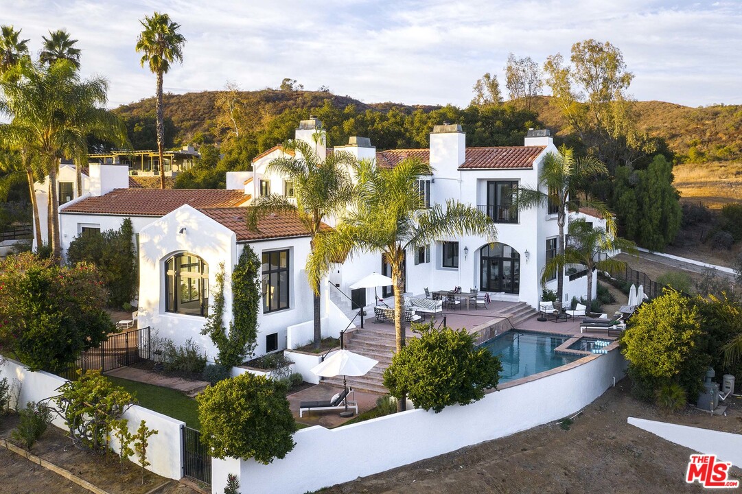 3170 Santa Maria Road Topanga, CA 90290 - Photo 3 of 60 a front view of a house with a yard garage and outdoor seating