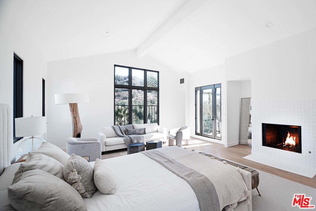 3170 Santa Maria Road Topanga, CA 90290 - Photo 32 of 60 a bedroom with furniture and a flat screen tv