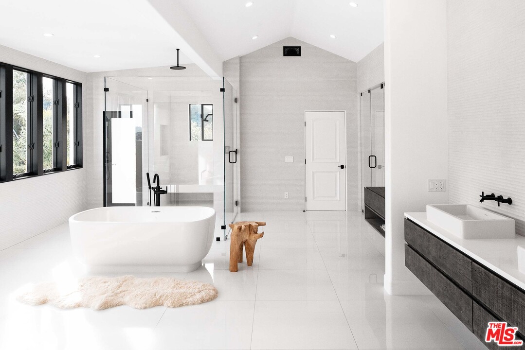 3170 Santa Maria Road Topanga, CA 90290 - Photo 35 of 60 a large white bathroom with a tub sink and mirror