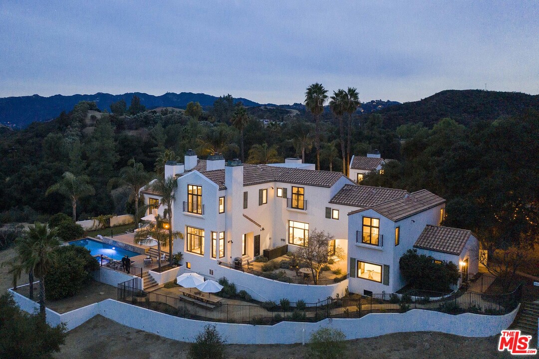3170 Santa Maria Road Topanga, CA 90290 - Photo 4 of 60 a front view of a house with a garden and lake view
