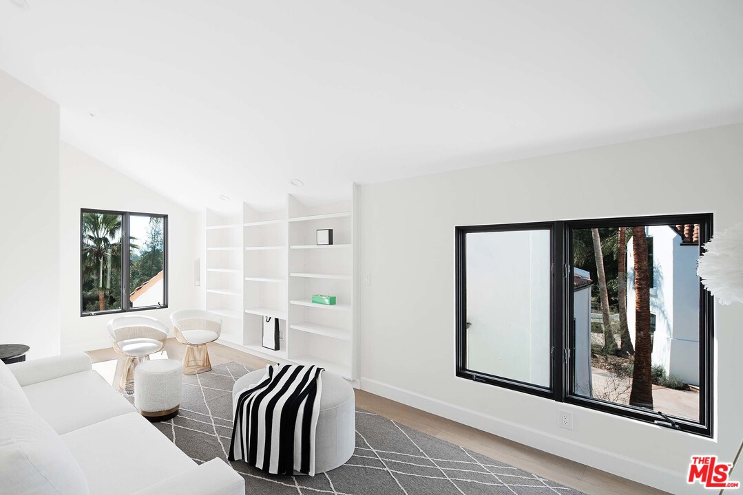 3170 Santa Maria Road Topanga, CA 90290 - Photo 42 of 60 a living room with furniture and windows