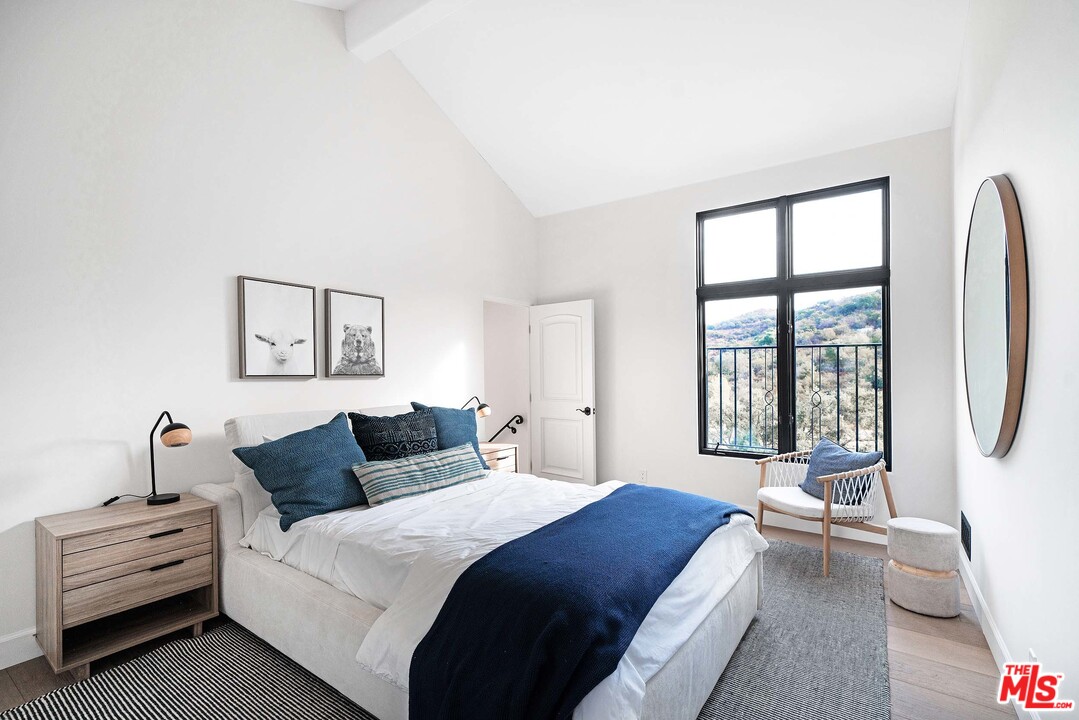 3170 Santa Maria Road Topanga, CA 90290 - Photo 46 of 60 a bedroom with a bed and a large window