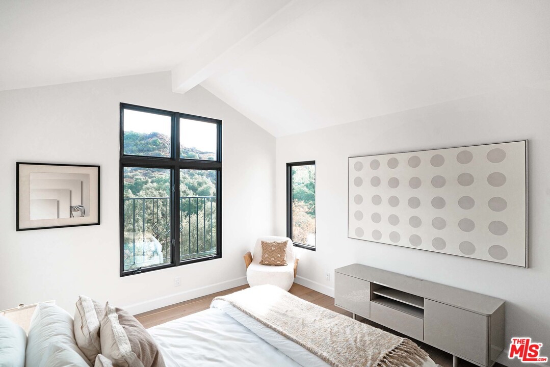 3170 Santa Maria Road Topanga, CA 90290 - Photo 48 of 60 a bedroom with a bed and wooden floor