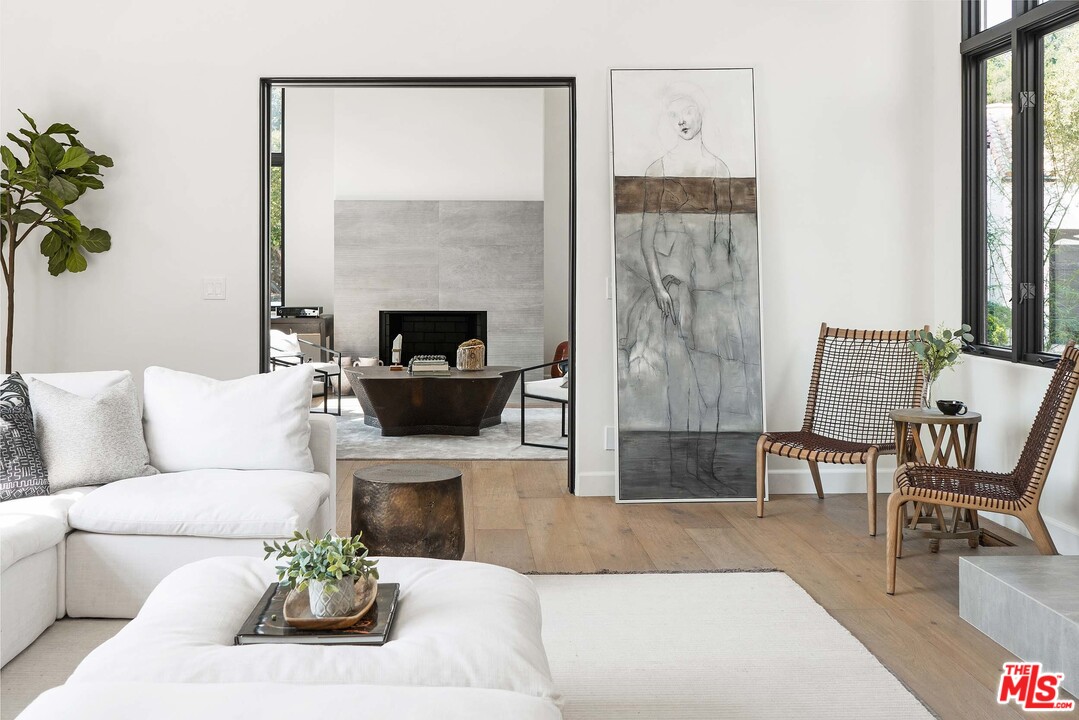 3170 Santa Maria Road Topanga, CA 90290 - Photo 9 of 60 a living room with furniture a table and a fireplace