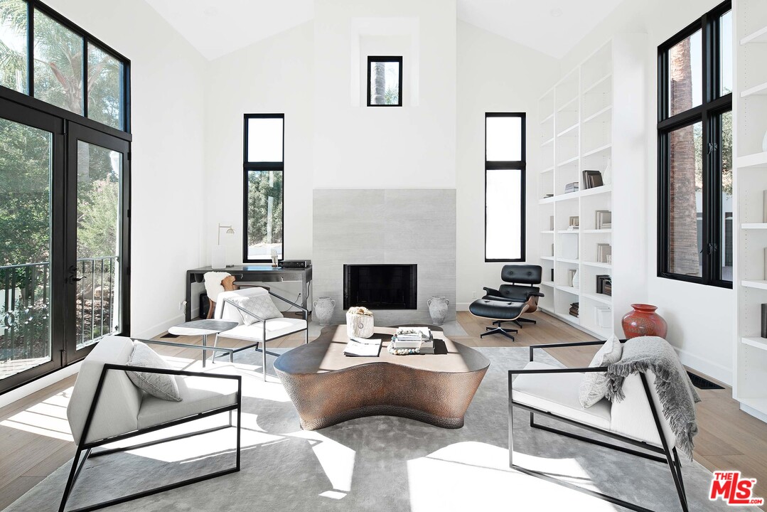 3170 Santa Maria Road Topanga, CA 90290 - Photo 10 of 60 a living room with furniture and a fireplace