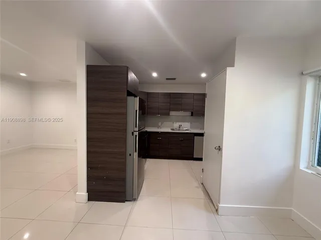a kitchen with a sink appliances and cabinets