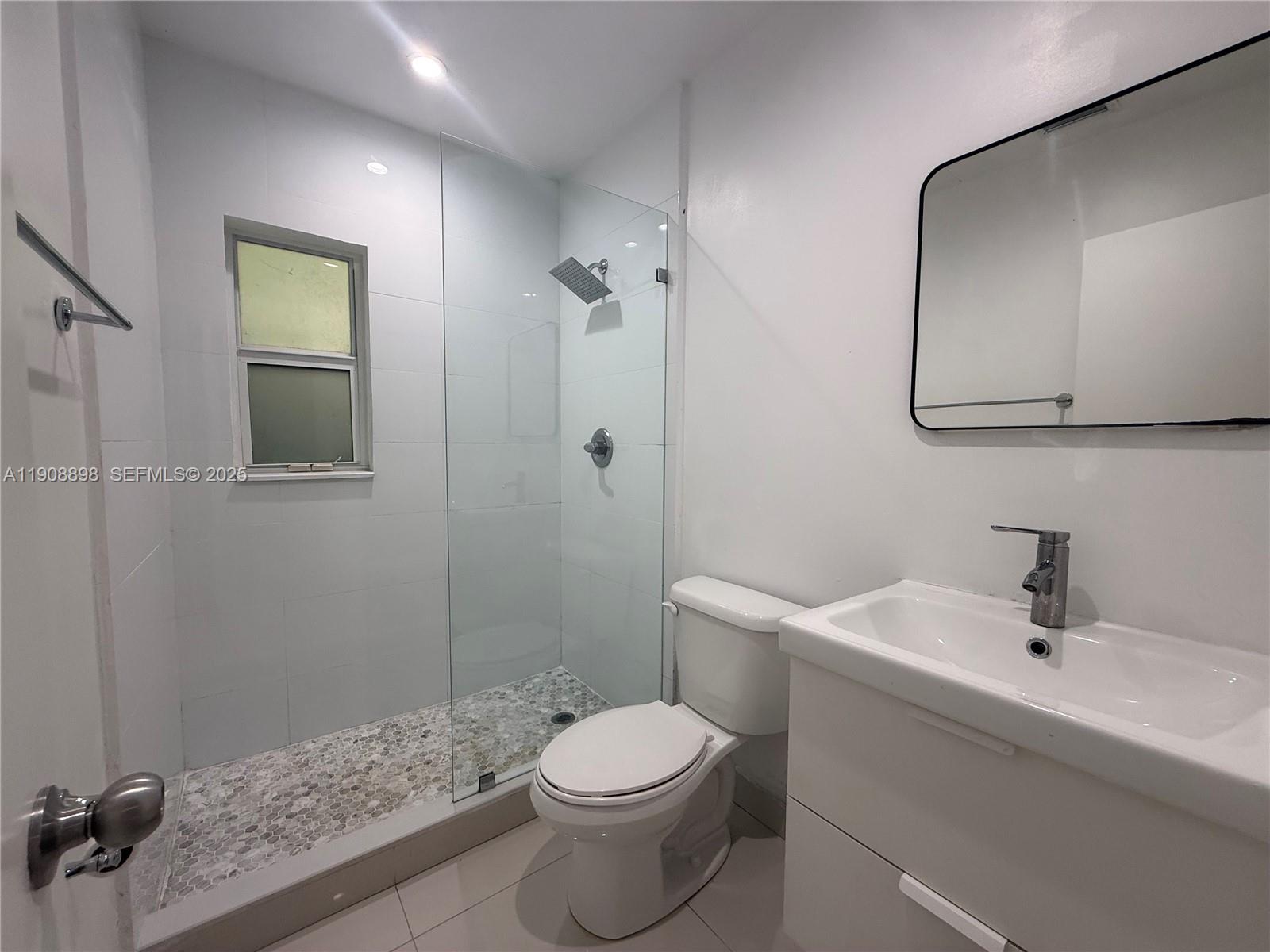 540 Northeast 67th Street, Unit 540 Miami, FL 33138 - Photo 7 of 16 a bathroom with a sink a toilet and shower