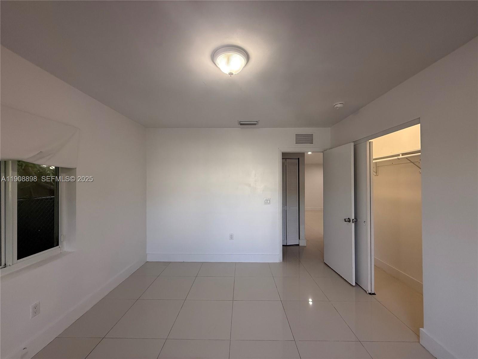 540 Northeast 67th Street, Unit 540 Miami, FL 33138 - Photo 9 of 16 wooden floor in an empty room