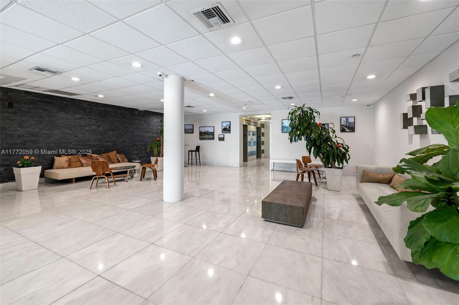 1035 West Avenue, Unit 507 Miami Beach, FL 33139 - Photo 11 of 22 a lobby with furniture and potted plants